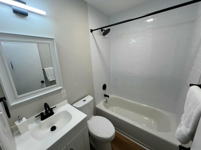 full bathroom featuring vanity, toilet, wood-type flooring, and tiled shower / bath