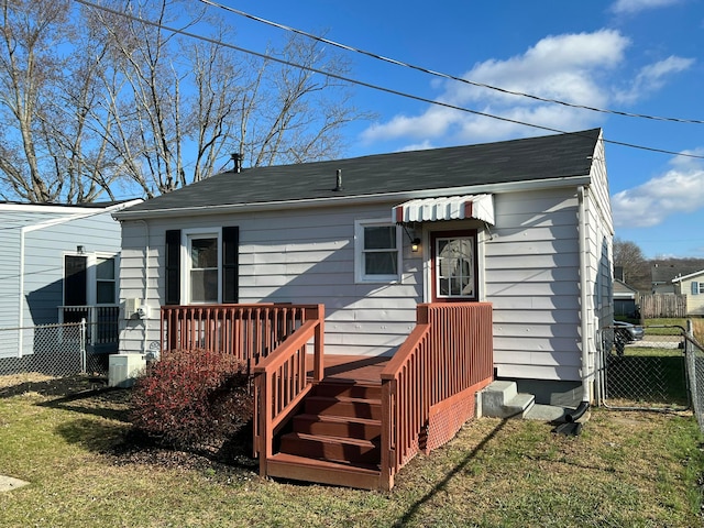 exterior space with a deck and a lawn