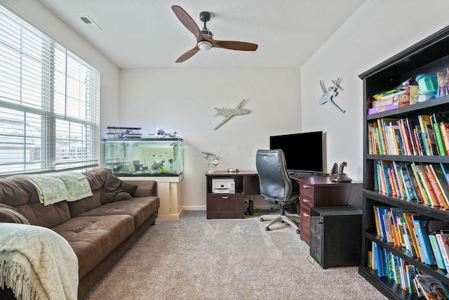 carpeted office with ceiling fan