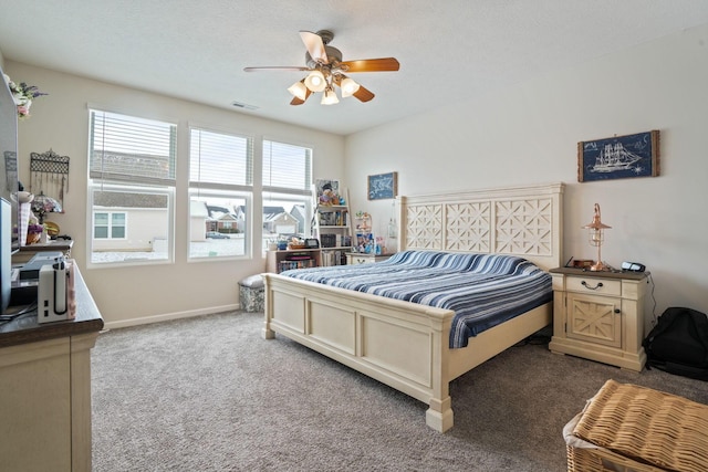 bedroom featuring ceiling fan, a textured ceiling, and carpet flooring