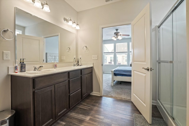 bathroom with vanity, ceiling fan, hardwood / wood-style floors, and a shower with door