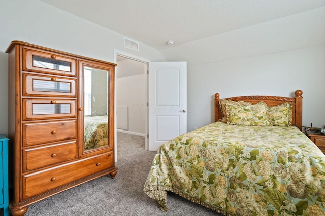 carpeted bedroom with lofted ceiling