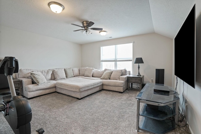 carpeted living room with vaulted ceiling, ceiling fan, and a textured ceiling