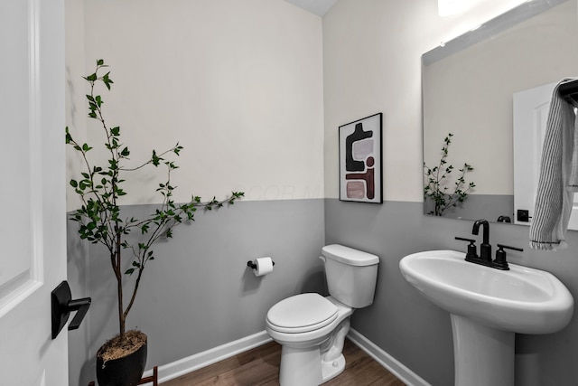 bathroom with wood-type flooring and toilet