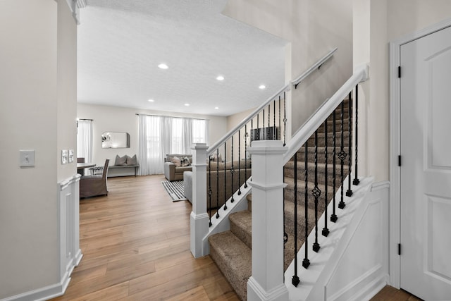 stairs with hardwood / wood-style floors