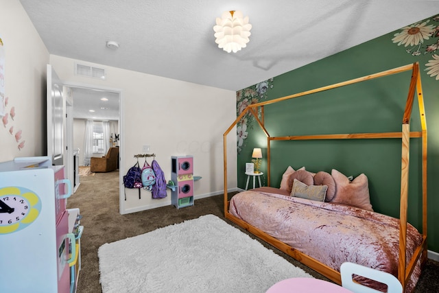 bedroom featuring dark colored carpet and a textured ceiling