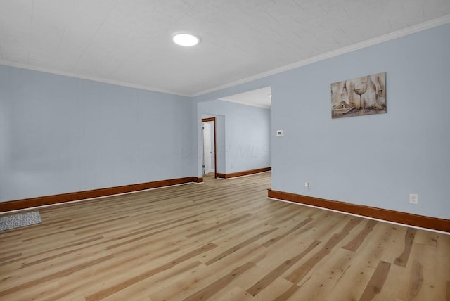 unfurnished room featuring light hardwood / wood-style floors and crown molding