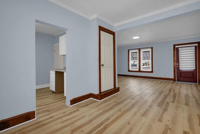 interior space with light hardwood / wood-style floors and ornamental molding