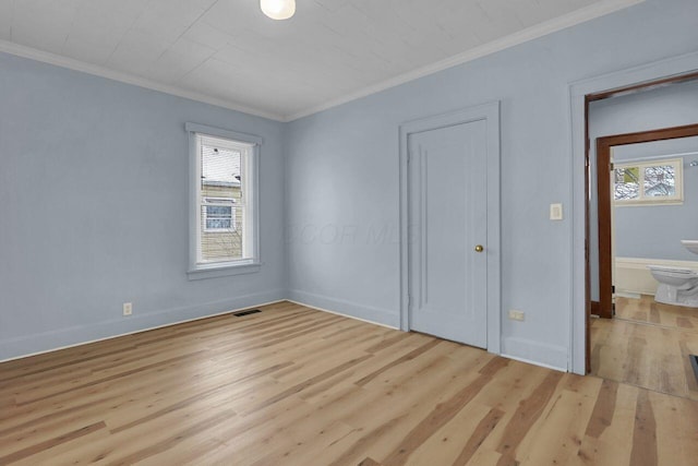 unfurnished bedroom with ensuite bath, crown molding, and light hardwood / wood-style flooring