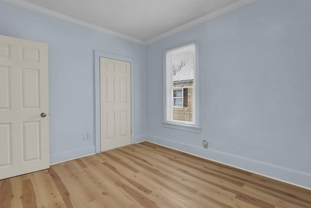 interior space with ornamental molding and light hardwood / wood-style flooring