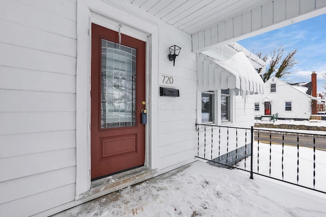 view of snow covered property entrance