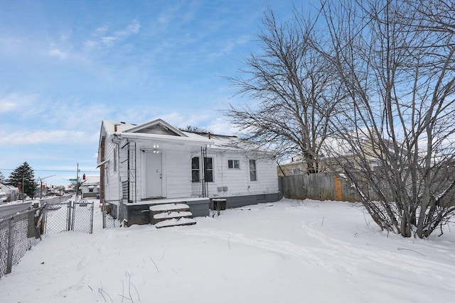 view of snow covered back of property