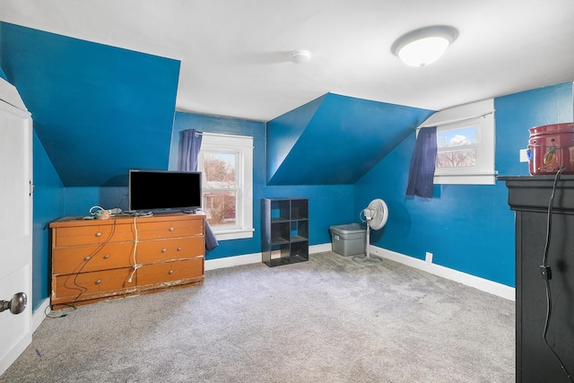 interior space with carpet floors and vaulted ceiling