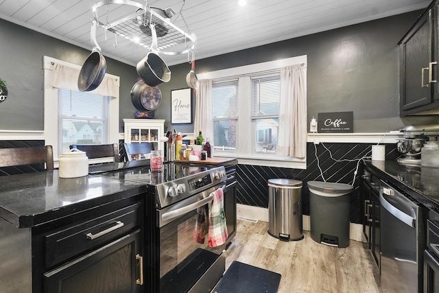 kitchen featuring light wood-type flooring, stainless steel appliances, and wooden ceiling