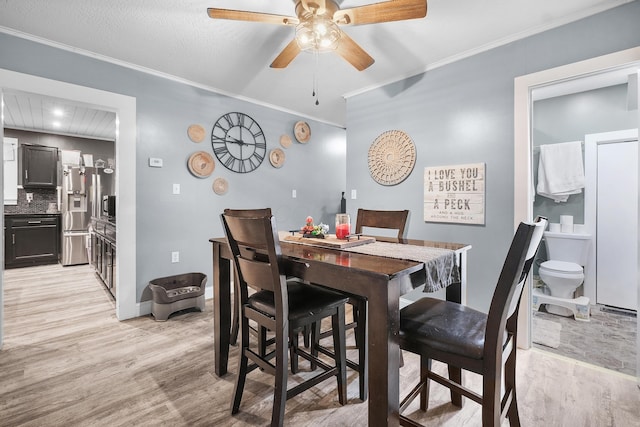 dining area with light hardwood / wood-style flooring, ceiling fan, and crown molding