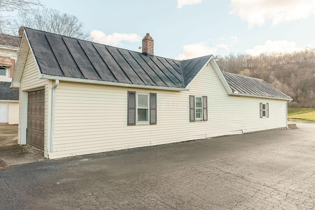 view of side of home with a garage