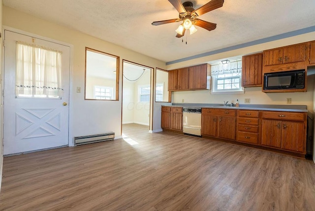 kitchen featuring ceiling fan, dishwasher, baseboard heating, light hardwood / wood-style floors, and a textured ceiling