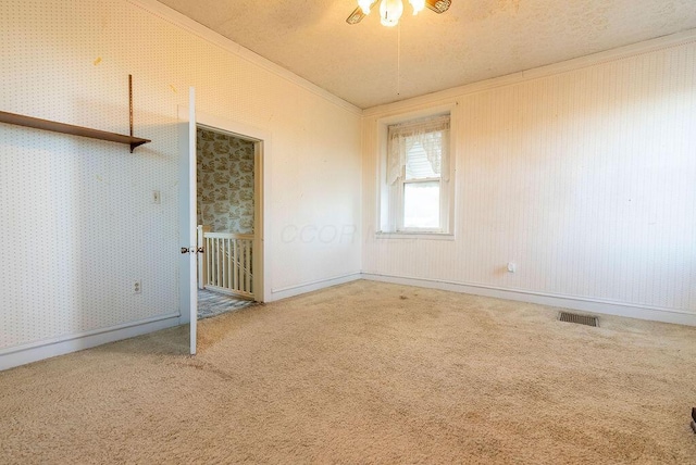 carpeted spare room with ornamental molding