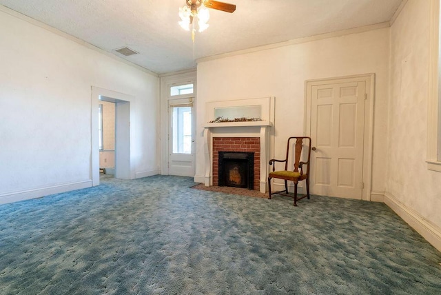 carpeted living room with ceiling fan, crown molding, and a brick fireplace