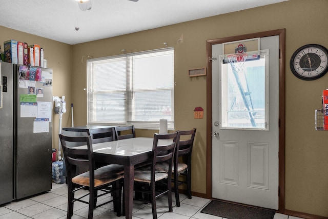 tiled dining area featuring plenty of natural light and ceiling fan