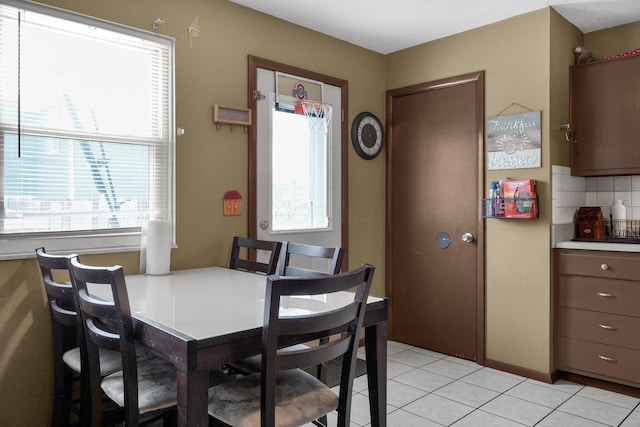 tiled dining area featuring plenty of natural light