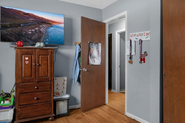 corridor with light hardwood / wood-style floors