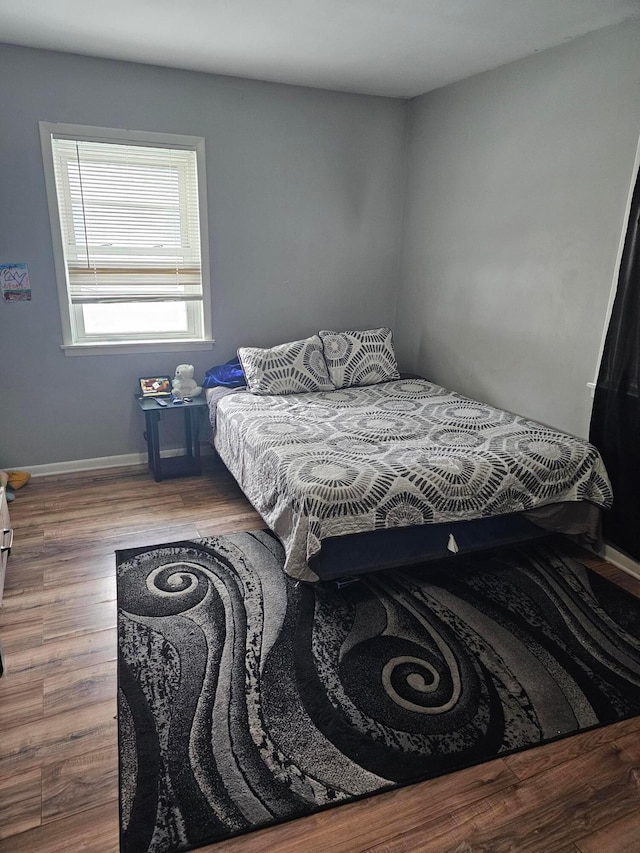 bedroom with hardwood / wood-style flooring