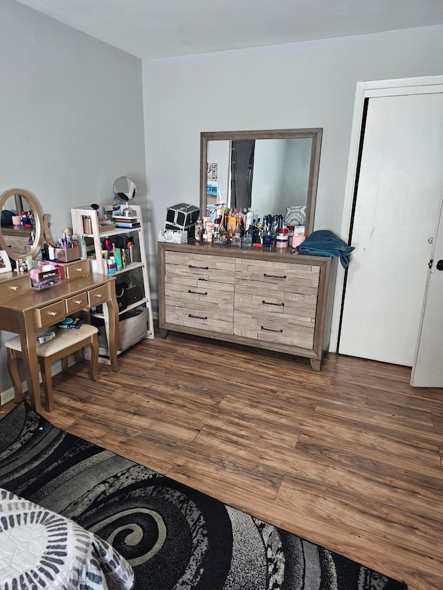 bedroom with dark hardwood / wood-style flooring