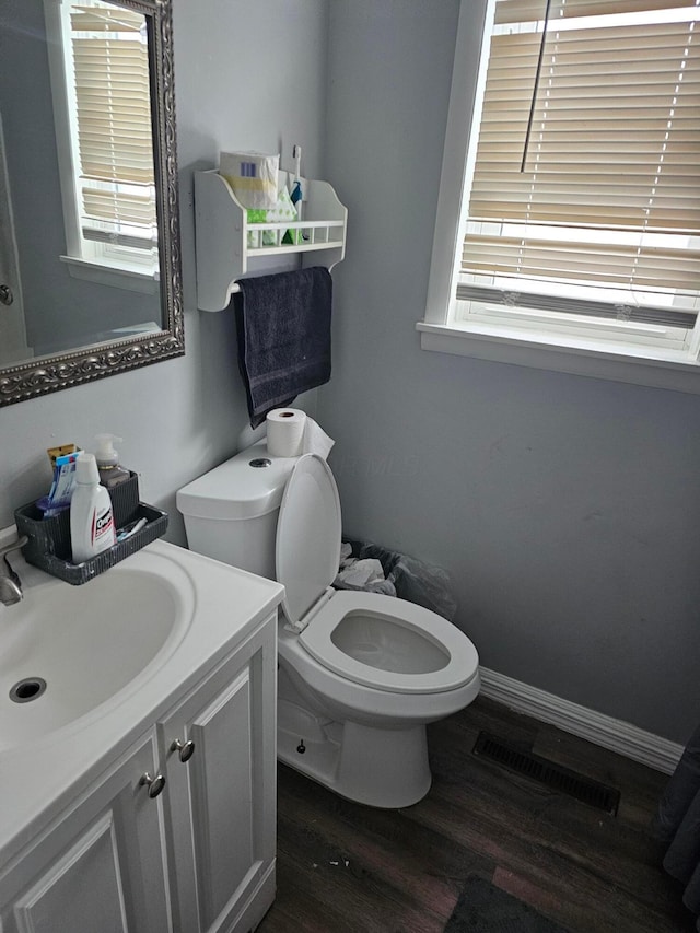 bathroom featuring hardwood / wood-style floors, vanity, and toilet