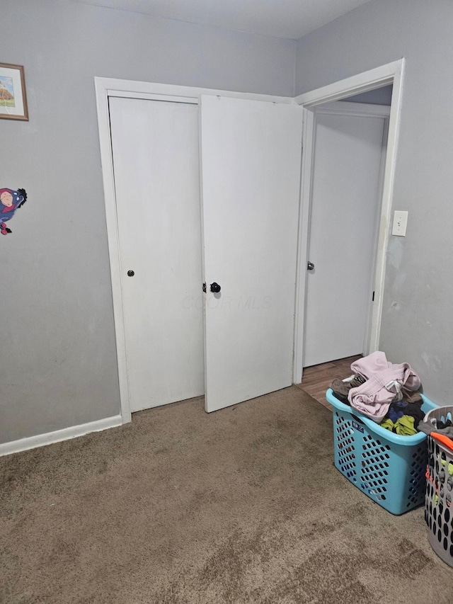 unfurnished bedroom with carpet and a closet