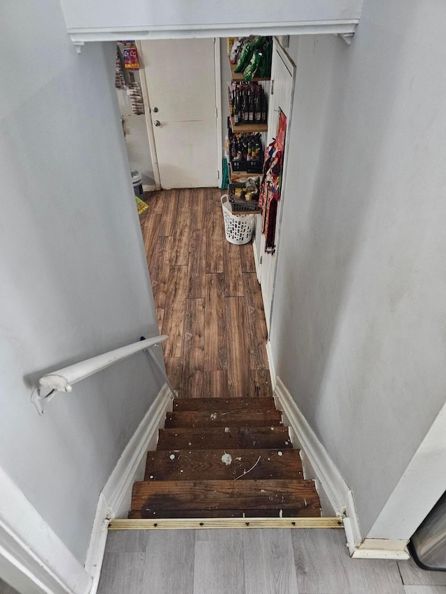 stairs featuring hardwood / wood-style floors