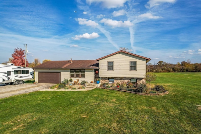 split level home with a front yard and a garage