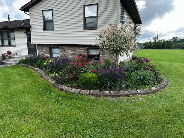 view of property exterior featuring a lawn