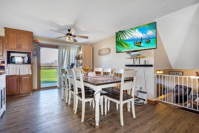 dining room featuring ceiling fan, dark hardwood / wood-style floors, and a textured ceiling