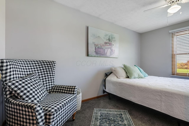 bedroom featuring a textured ceiling, carpet floors, and ceiling fan