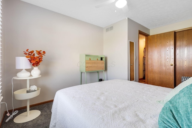 bedroom featuring ceiling fan, a closet, and carpet