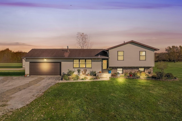 split level home featuring a yard and a garage