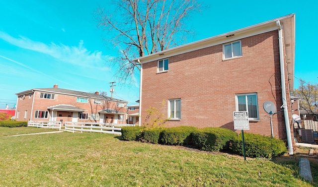 rear view of property with a yard