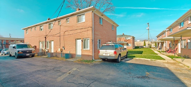 view of side of home with central AC unit