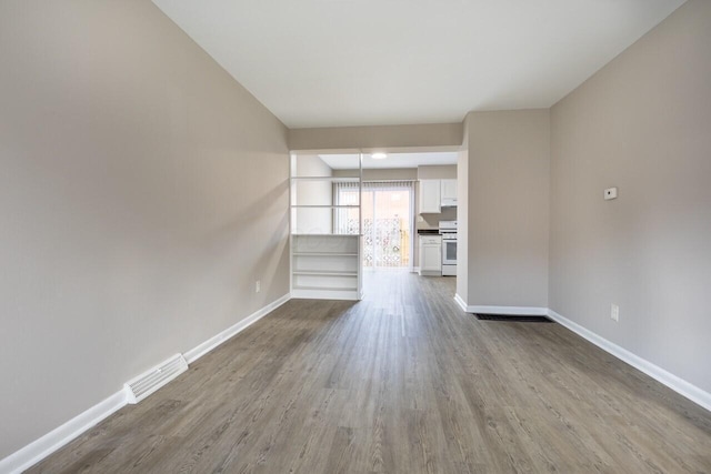 unfurnished living room with wood-type flooring