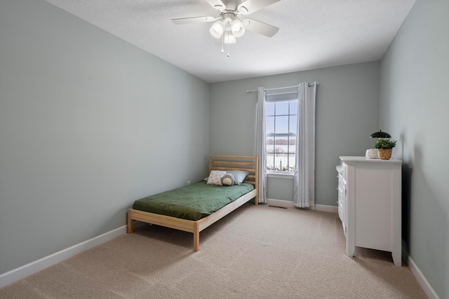 bedroom with ceiling fan and light colored carpet