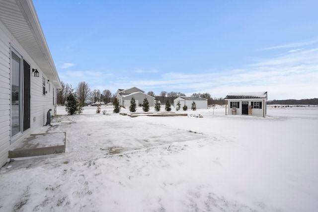 yard layered in snow with an outdoor structure