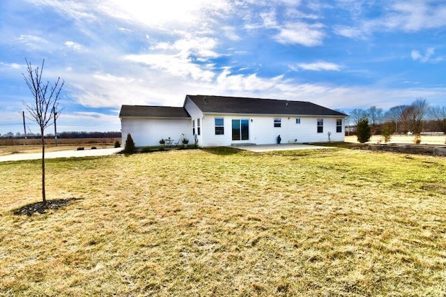 rear view of house featuring a yard and a patio area