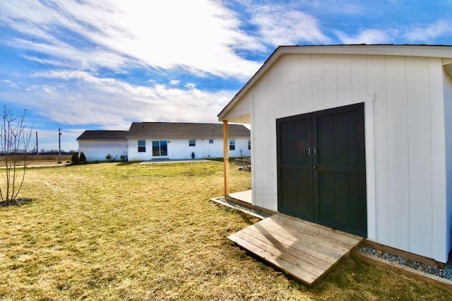 view of outbuilding featuring a yard