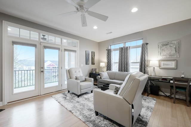 living room with french doors, ceiling fan, and light hardwood / wood-style floors