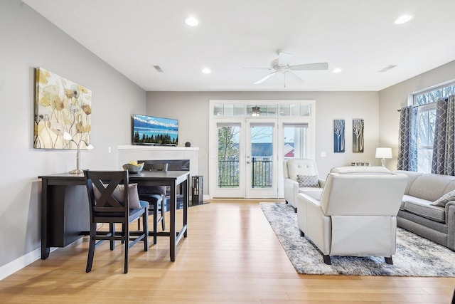 living room featuring ceiling fan, french doors, and light wood-type flooring