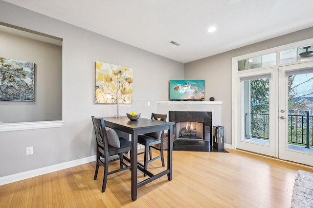 dining space with light hardwood / wood-style flooring