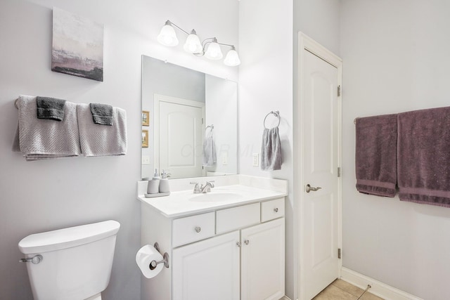 bathroom with toilet, tile patterned floors, and vanity