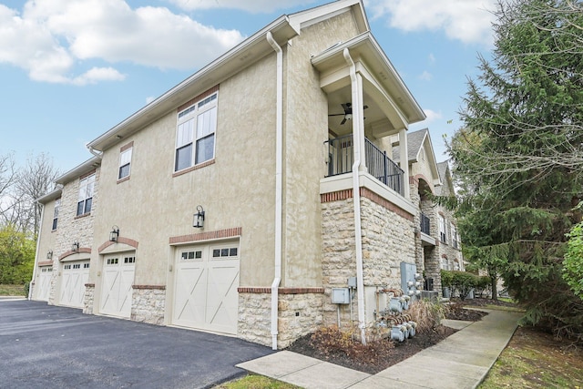 view of property exterior with a balcony and a garage