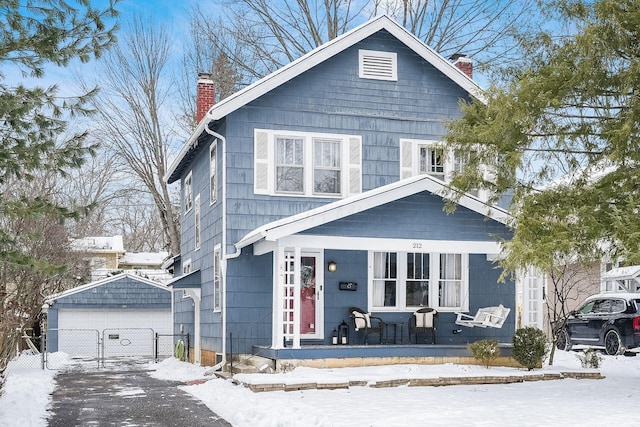 view of front facade with a porch, an outdoor structure, and a garage